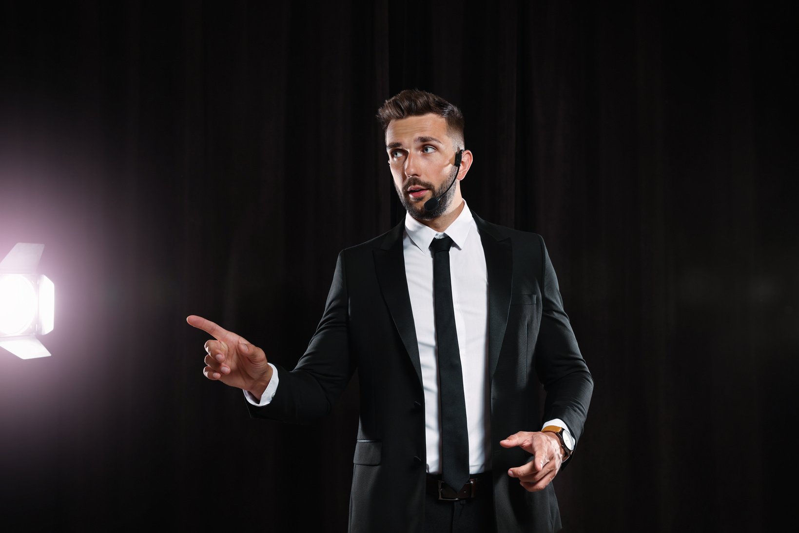 Motivational Speaker with Headset Performing on Stage